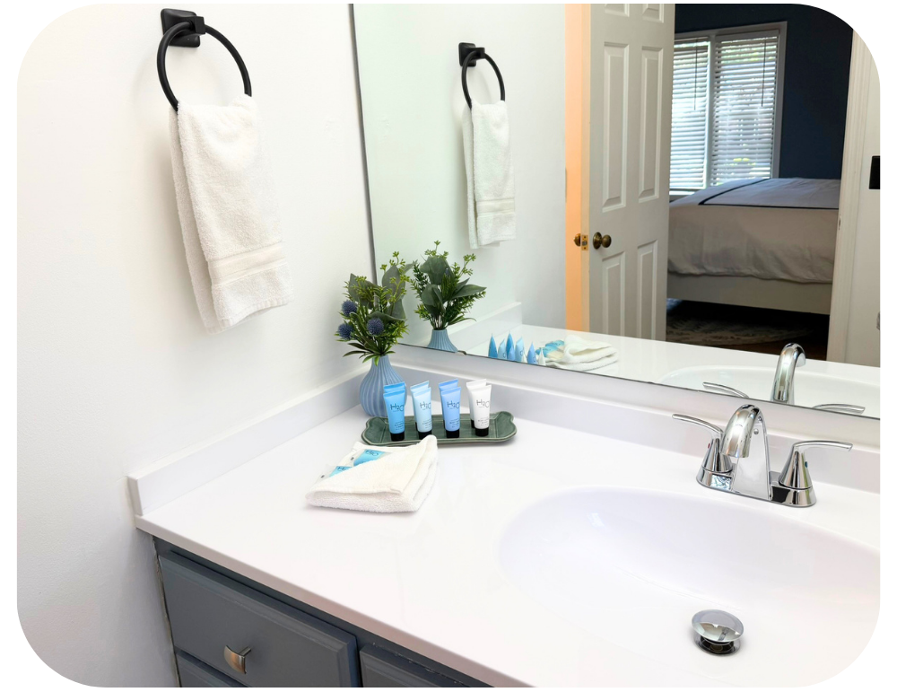 Airbnb restocking checklist bathroom vanity restocked with fresh amenities and towels